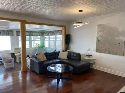 a living room with a couch and a table at Water Front Beach House - 3BR w BBQ & Sunset in Fort Erie