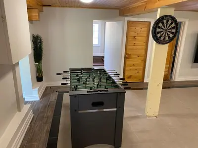 a room with a dart board on the wall at Water Front Beach House - 3BR w BBQ & Sunset in Fort Erie