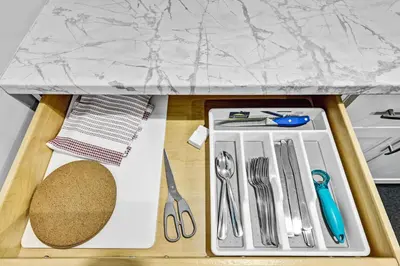 a table with utensils on a cutting board at NEW 5 Bedroom House Near The Falls in Niagara Falls
