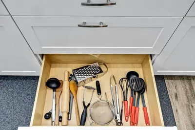a drawer filled with cooking utensils under a drawer at NEW 5 Bedroom House Near The Falls in Niagara Falls
