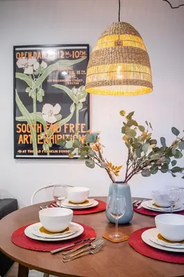 a dining room table with plates and a chandelier at Basement Suite for 2 w Private Patio in Toronto in Toronto