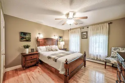 a bedroom with a bed and a ceiling fan at Charlotte Garden Bed and Breakfast in Niagara on the Lake