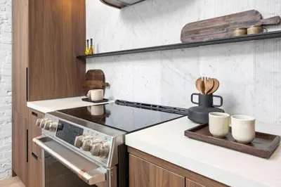 a kitchen with a stove and some cups on a counter at The Brick Hotel - The Loft in Toronto