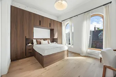 a bedroom with a bed and a large window at The Brick Hotel - The Loft in Toronto