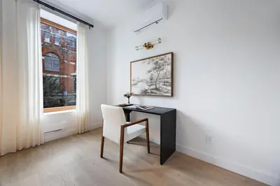 a desk and a chair in a room with a window at The Brick Hotel - The Second Suite in Toronto