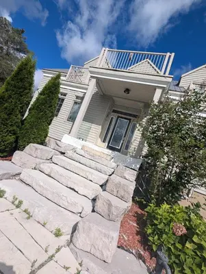 a house with a set of stairs in front of it at Nature & Comfort - Private Manor in Innisfil