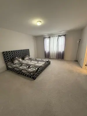 a bedroom with a bed in the corner of a room at Short Term Cozy Stay in Beautiful Fergus in Fergus