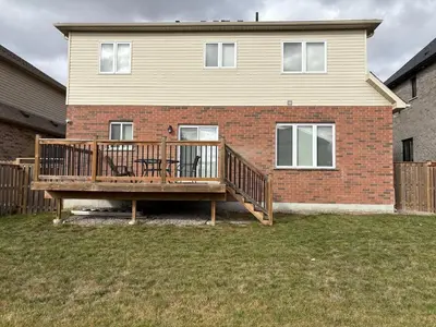 a large wooden deck in front of a house at Entire home in London, Ontario, Canada in London