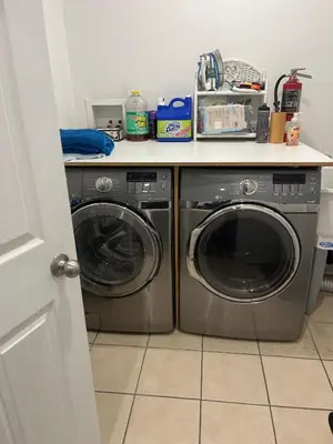 a kitchen with a washer and dryer under a counter at Places to stay bbq ac heat parking wiffi in Kawartha Lakes