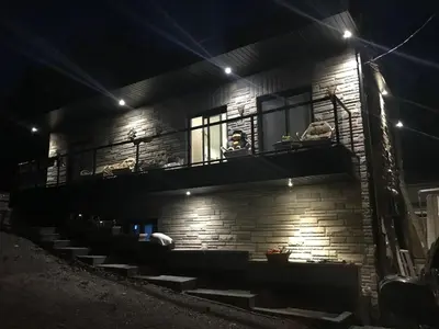 a brick building with a balcony at night at Places to stay bbq ac heat parking wiffi in Kawartha Lakes