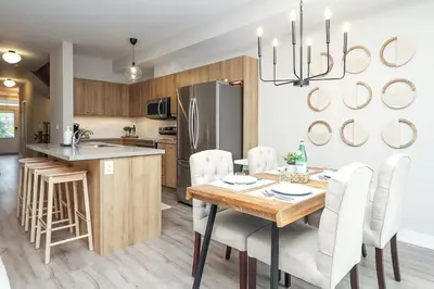 a kitchen and dining room with a table and chairs at Peak Perfection at The Blue Mountains in Blue Mountains