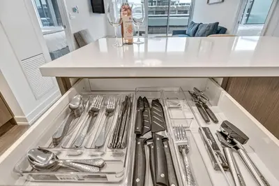 a drawer filled with silver utensils in a kitchen at Your Friday Harbour Escape Awaits! in Innisfil