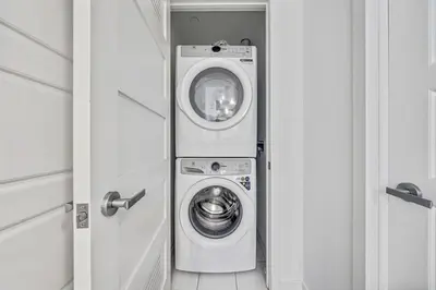 a washer and dryer sitting in a room at Your Friday Harbour Escape Awaits! in Innisfil