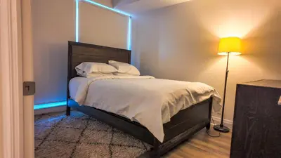 a bedroom with a bed with a large mirror on the wall at 17 Zorra street in Toronto