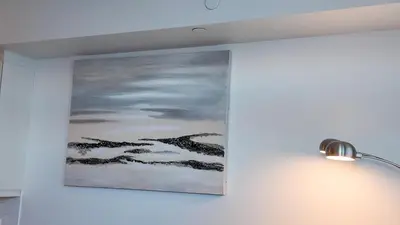a painting hanging on a wall next to a lamp at 17 Zorra street in Toronto