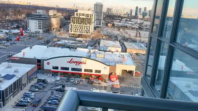 an aerial view of a city with a shopping center at 17 Zorra street in Toronto