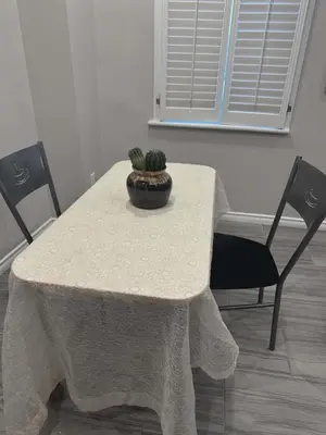 a table with two chairs and a cactus on it at Home Base Executive Rental in Hamilton in Hamilton