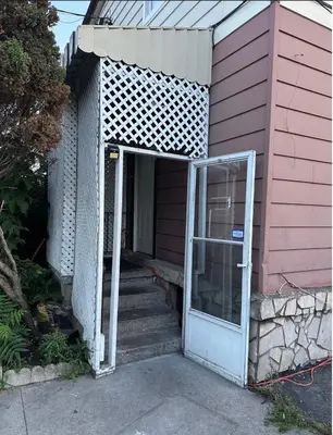 an open door to a pink house with stairs at Space Share Accommodation East York Budget Friendly in Toronto