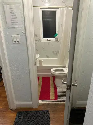 a bathroom with a white toilet and a window at Space Share Accommodation East York Budget Friendly in Toronto