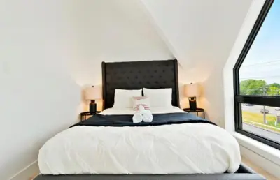 a bedroom with a bed with two teddy bears on it at 2Bdrm Penthouse Close To Falls With Parking in Niagara Falls