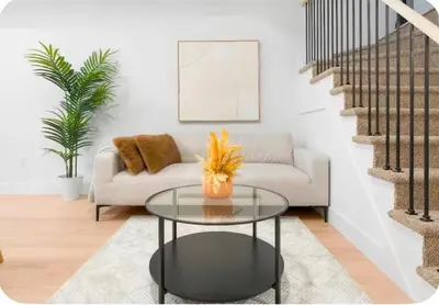 a living room with a couch and a glass table at 2Bdrm Penthouse Close To Falls With Parking in Niagara Falls