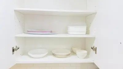 a kitchen with white shelves with plates and bowls at Newly Renovated Private Suite Separate Entrance in Richmond Hill