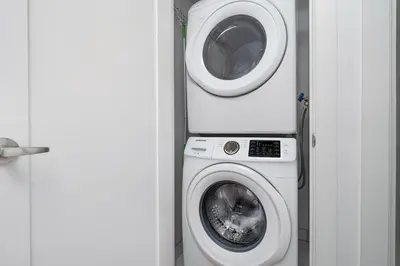 a washing machine and a dryer in a room at Comfort and Beauty in the heart of Tor | W Parking in Toronto