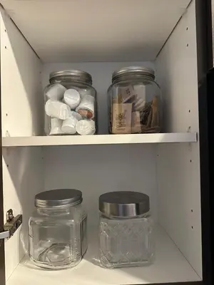 a pantry with jars sitting on a shelf at Brightly Lit Suite Centrally Located |UofT|Ryerson in Toronto