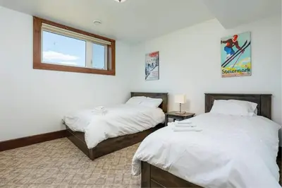 a bedroom with two beds and a window at Grand 8-Bedroom Retreat 7 Baths Hot Tubs - Perfect Chalet in Blue Mountains
