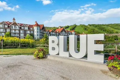 a large sign in front of a resort at Grand 8-Bedroom Retreat 7 Baths Hot Tubs - Perfect Chalet in Blue Mountains