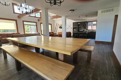 a large wooden table in a living room at Grand 8-Bedroom Retreat 7 Baths Hot Tubs - Perfect Chalet in Blue Mountains