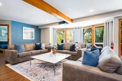 a living room with couches and a coffee table at Large Chalet Hideaway - Hottub-SwimSpa - Sauna in Blue Mountains