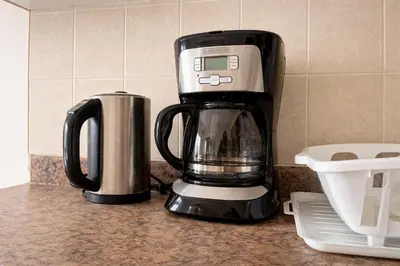a black and white coffee maker on a counter at Private & Spacious King-size Bedroom with 3 Bath access! Brampton Shared Home with Full Kitchen, WiFi, Laundry & Backyard Deck! Near Mount Pleasant GO, Ideal for Work Trips, Long Stays & Solo Travelers! in Brampton