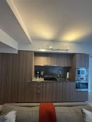 a living room with a couch and a kitchen at Apartment for 4 trundle Bay in Port Hope