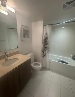 a bathroom with a toilet and a sink and a tub at Apartment for 4 trundle Bay in Port Hope