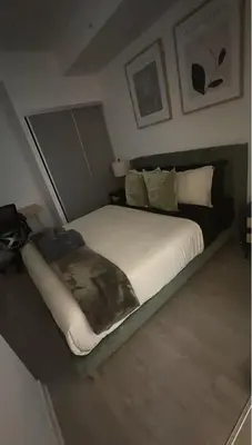 a bedroom with a large bed in a room at Condo with grey sofa bed in Port Hope