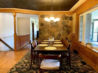 a dining room with a table and chairs at Cajun Cabin Private Nature Resort in Minden
