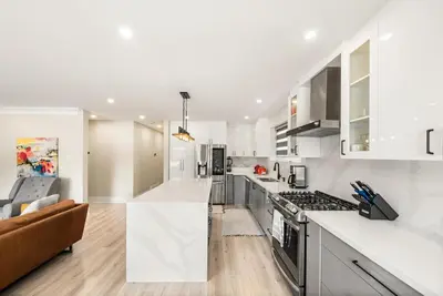 a kitchen with white cabinets and a stove top oven at 5 Bedroom Luxury Spa Escape with Pool & Jacuzzi in Toronto