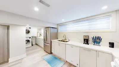 a kitchen with white cabinets and a window at 5 Bedroom Luxury Spa Escape with Pool & Jacuzzi in Toronto
