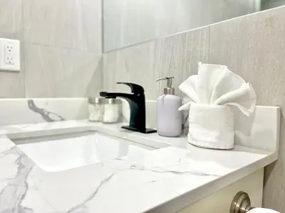 a bathroom counter with a sink and a faucet at Violet Escape Modern Apt 1B 1B, Kitchen, Parking in Richmond Hill
