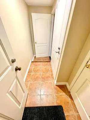a hallway with a door and a tile floor at Violet Escape Modern Apt 1B 1B, Kitchen, Parking in Richmond Hill