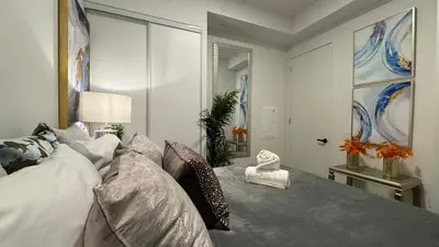 a bedroom with a large white bed with aavid at Prestige Upper Series 1-Bedroom Condo at Vaughan Metropolitan Centre in Vaughan