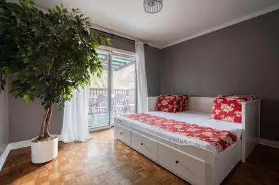 a bedroom with a bed with red pillows and a tree at Spacious Bright Home In Woodbridge in Vaughan