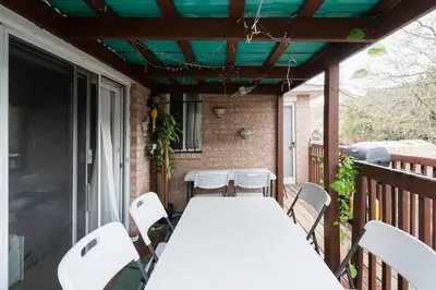 a table and chairs on a porch with a green ceiling at Spacious Bright Home In Woodbridge in Vaughan