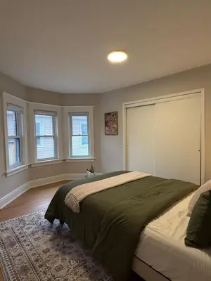 a bedroom with a large bed and two windows at The Maple and Mist in Niagara Falls