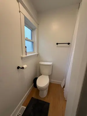 a bathroom with a toilet and a window at The Maple and Mist in Niagara Falls