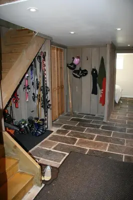 a room with a bunch of skis on the wall at Lake Eugenia Escape - Cozy Lakefront with Hot Tub in Flesherton