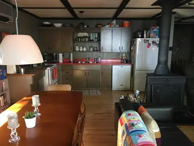a kitchen with a table and a kitchen with a stove at Lake Eugenia Escape - Cozy Lakefront with Hot Tub in Flesherton