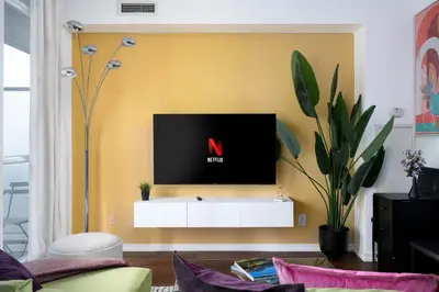 a living room with a tv on a wall at Live the excitement Stay next to Scotiabank Arena! in Toronto