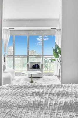 a living room with a large window and a couch at Charming lakeview suite with parking in Toronto